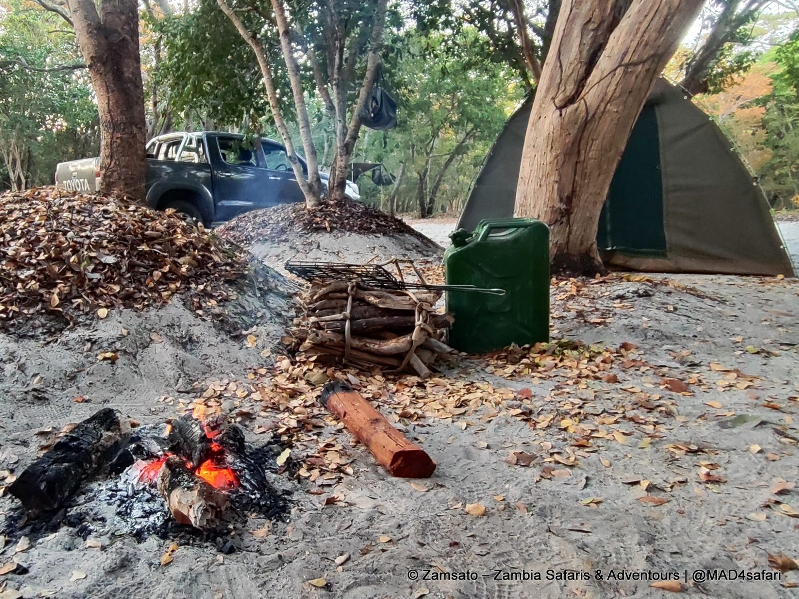 Campfire and tent at a Zamsato camp on Liuwa Plain