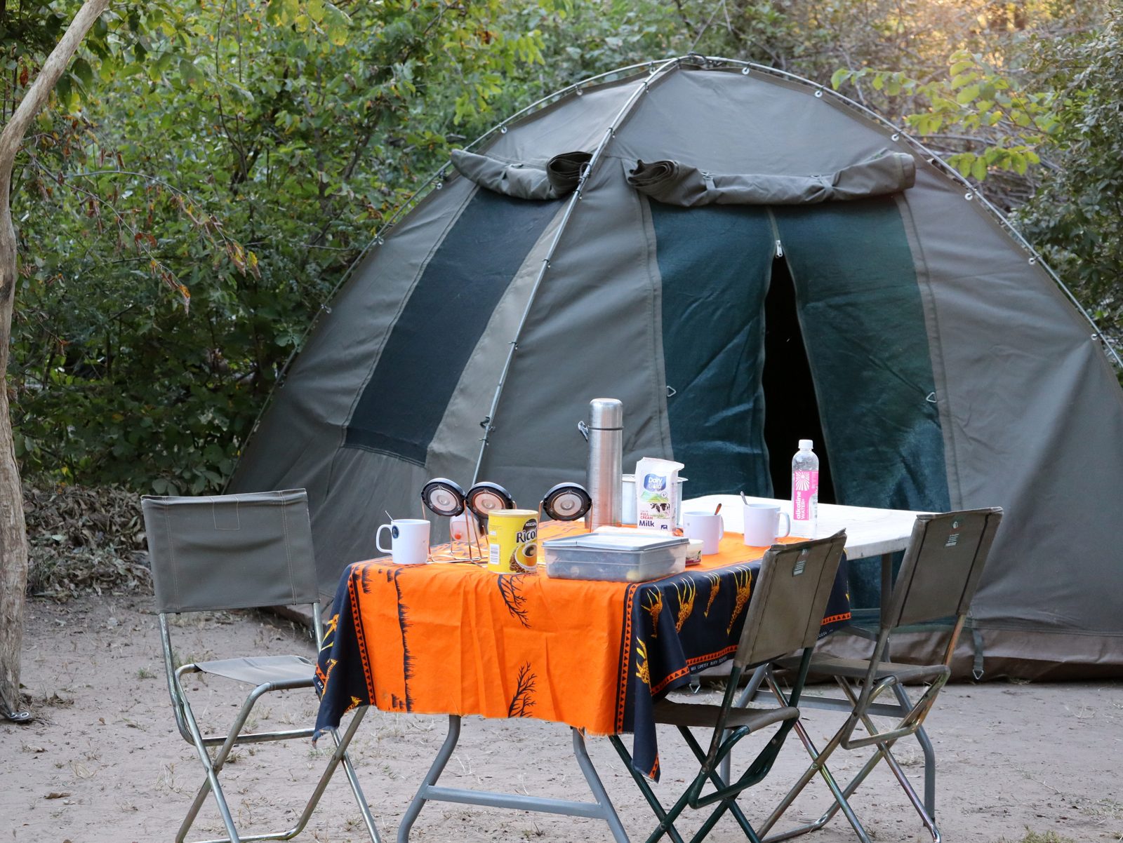 Zamsato canvas tent with table set for breakfast in Kafue National Park